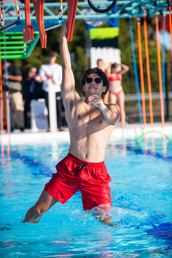 indoor aquatic center obstacle course vibrant community recreation pool programming cinematic lighting